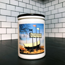Load image into Gallery viewer, KCMOCO. Westport Candle in KC Collection Jar: White glass jar with photo label depicting photo of Westport wagon, with black bamboo lid, on kitchen cabinet.
