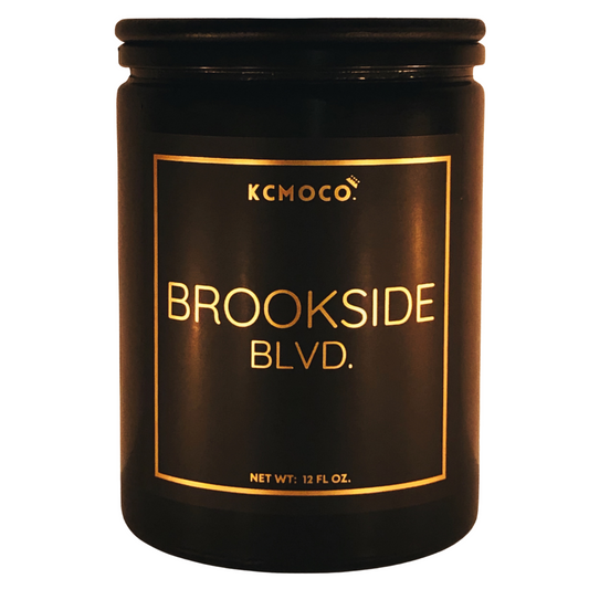 KCMOCO. Candles Brookside Blvd. Candle in Classic Collection Jar: Black glass jar with gold foil label reading "KCMOCO. Brookside Blvd.", with black bamboo lid.